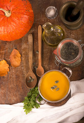 pumpkin soup on rustic wooden background