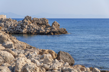 Peaceful view of sea stone rocky coast beach with blue sea background