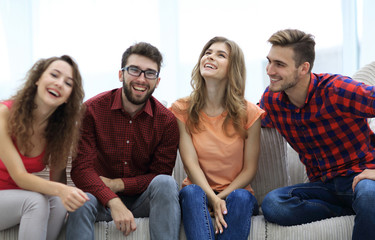 Fototapeta premium group of cheerful young people sitting on the couch.
