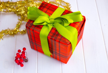 Christmas toys and garland on a white wooden background