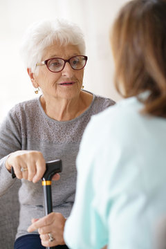 Nurse talking to old woman, assistance and support
