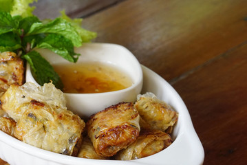 Closed up shot of deep fried spring rolls serving with plum sauce