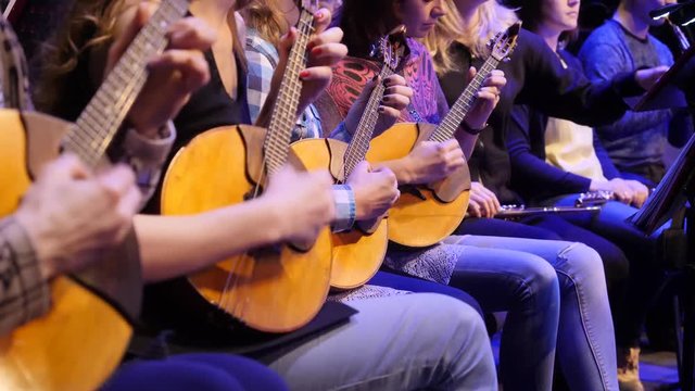 Woman playing music with balalaika. Lifestyle concept. Russian instrument. Folk music russian ensemble - woman playing the balalaika