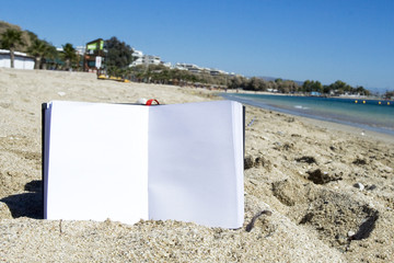 a notebook on the sand