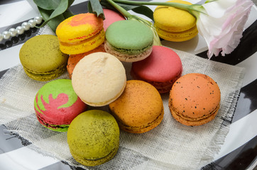 Sweet and colorful macarons. Closeup macaroons on a plate. Tasty french delicate dessert for breakfast.