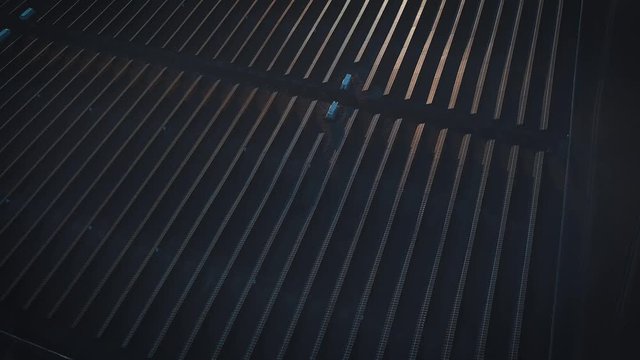 Aerial shot of solar panels - solar power plant. 4k slow motion aerial shot. Aerial desert view large industrial Solar Energy Farm producing concentrated solar power