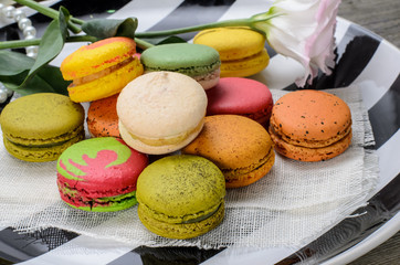 Sweet and colorful macarons. Closeup macaroons on a plate. Tasty french delicate dessert for breakfast.