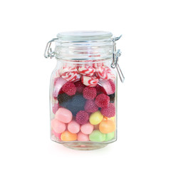 Glass jar with many bright sweet candies isolated on white background