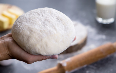 Hands working with dough preparation recipe bread, pizza or pie making ingridients