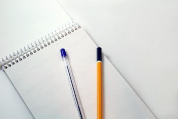 Notepad with pencil and pen