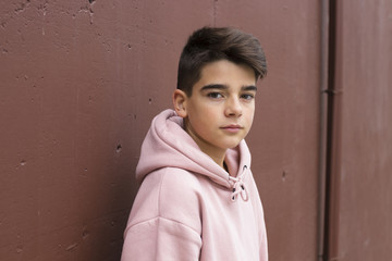 portrait of young preteen on the wall of the street in the city