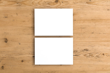 Blank white business card postcard flyer on a wooden background