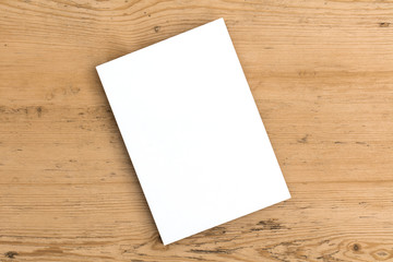 Blank white business card postcard flyer on a wooden background