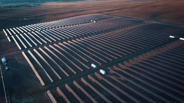 Aerial shot of solar panels - solar power plant. 4k slow motion aerial shot. Aerial desert view large industrial Solar Energy Farm producing concentrated solar power