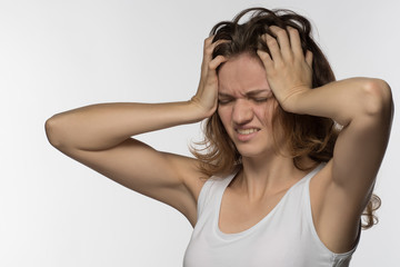 Young girl experiencing headache or depression and mourned over white background