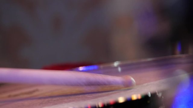 drumsticks in the hands of a drummer, live Jazz concert. Slow motion close-up