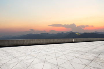 empty marble floor with green mountains at twilight