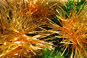 Green and gold festive tinsel for Christmas background