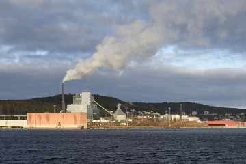 District heating plant with lot of smoke comming out of chimney