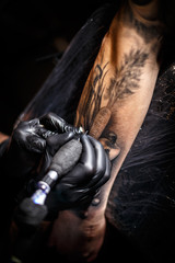 Fototapeta na wymiar Tattoo artist doing tattoos
