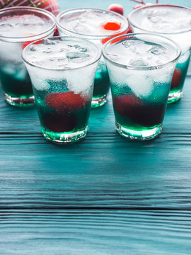 Short alcohol green drinks with cherry and crushed ice. Christmas Saint Patrick day holiday shot