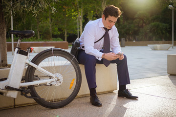 Young buinessman riding to work in the city