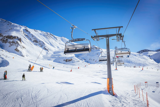 Sunny day in the Austrian Alps - ski tracks, ski lifts and snow mountains