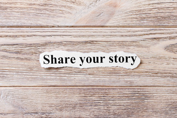 Share your story of the word on paper. concept. Words of Share your story on a wooden background