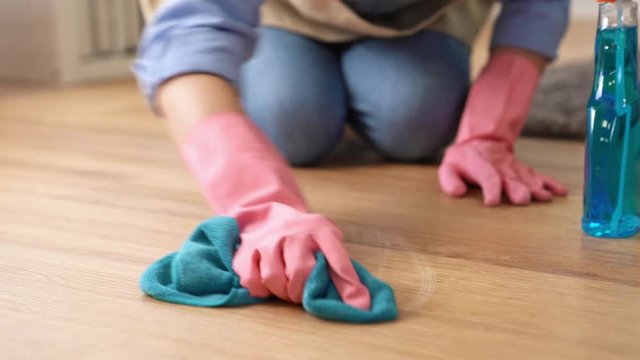 Woman uses cleaner and rag to work hard