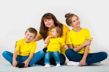 Portrait of a happy large family on a gray background. Mother and her children