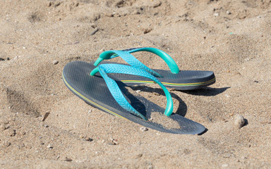 Blue and green flip flops