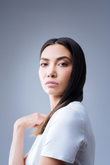 Obraz premium Clever manager. Calm strict experienced manager feeling confident while standing against the blue background and looking at the workers