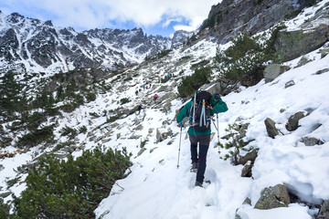 Fototapeta na wymiar Man with backpack trekking in Tatra mountains, Poland
