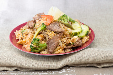 Homemade beef fried rice with vegetables and fried eggs