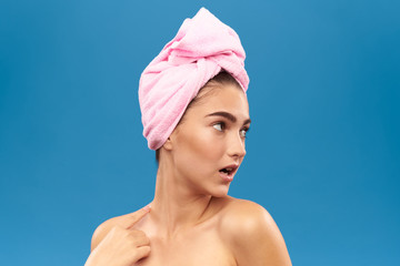 girl with a pink towel looking away