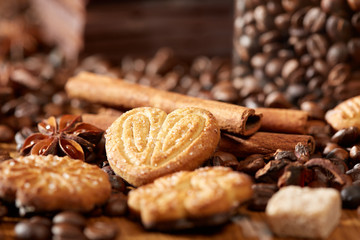Aroma coffee chocolate cookies and spices on the wooden table. Dark wooden background. Top view. Close. Closeup.
