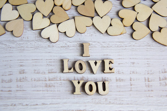 Heart shape from natural tree. Lovely heart shape by wooden small hearts on rustic wood table. Love theme concept with wooden hearts for Valentine's background and love theme.wooden leters i love you.