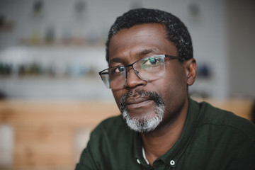 mature african american man in bar - Powered by Adobe