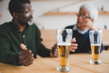 senior friends talking at bar