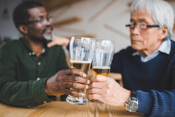 senior friends clinking glasses