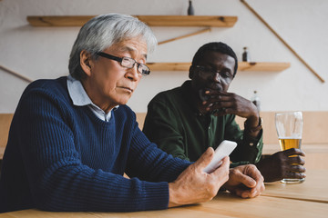 depressed senior men sitting in bar