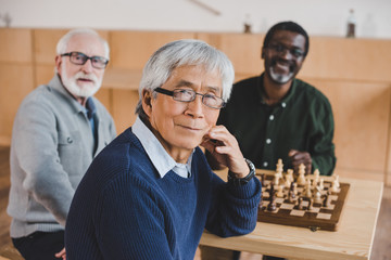 senior friends playing chess