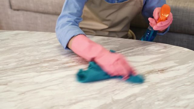 Maid wiped the table with detergent and rag