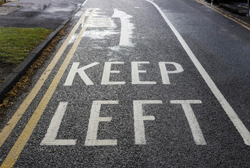 Keep left writing on road surface