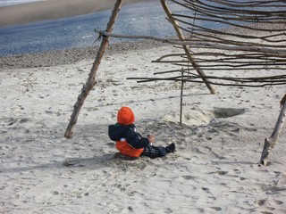  child playing in the sand near the sea