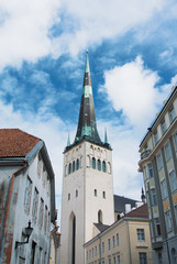 Fototapeta na wymiar A tower of Saint Olaf's Church in the center of Tallinn Old town on cloudy day.