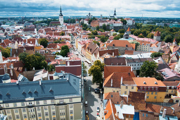 Aerial panoramic view of Tallinn old town city center and narrow medieval streets on cloudy day, Estonia.