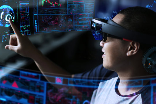 Men steps into virtual reality world with hololens. Business man try virtual reality glasses hololens 1 in the dark room with advanced technology. Future technology concept. 