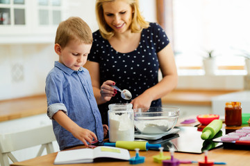 Mother and child preparing cookies