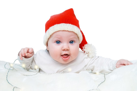 Funny baby in a red Santa hat.